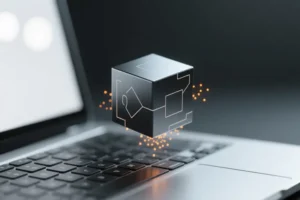A compact smooth dark titanium cube floating gently just above a sleek silver laptop keyboard.