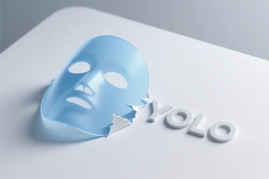 A large mask with text next to it that reads YOLO