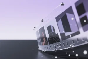 A large towering translucent video film strip gradually transitioning from blurred abstract geometric blocks.