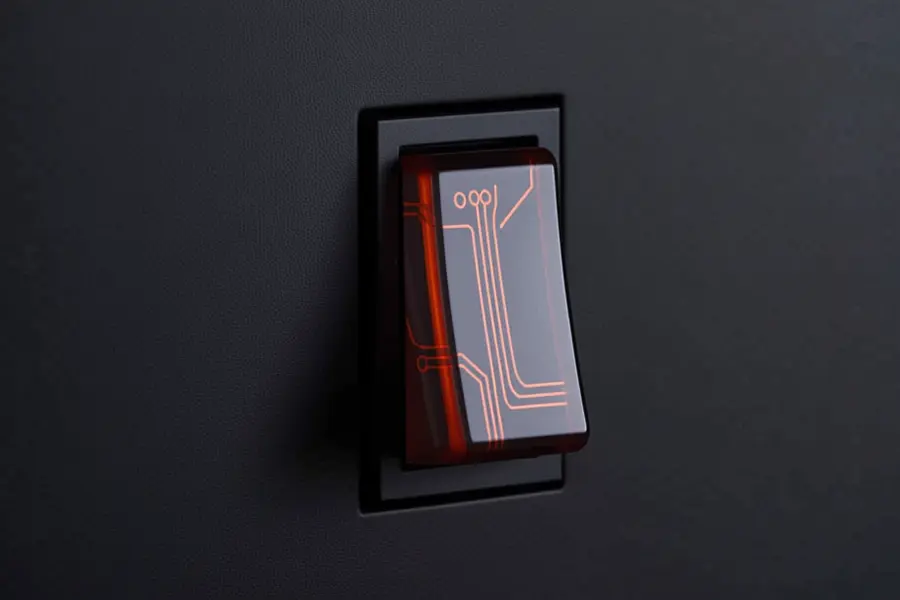 A simple dark color dimmer switch with soft translucent material with light orange circuitry.