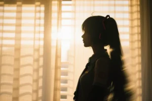 An abstract, highly emotive and motion-blurred film photograph capturing the silhouette of a hatsune miku.