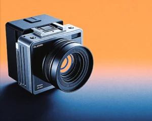 A modern digital film camera of dark brushed metallic texture and subtle holographic interfaces.