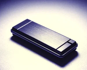 Compact flash drive of polished metallic brushed texture illuminated by soft ambient glow.